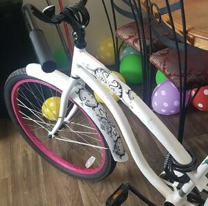 Mango White Cruiser Bicycle with Pink Front Rim and Black Accents
